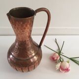 Pitcher-shaped vase in hammered copper