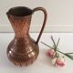 Pitcher-shaped vase in hammered copper