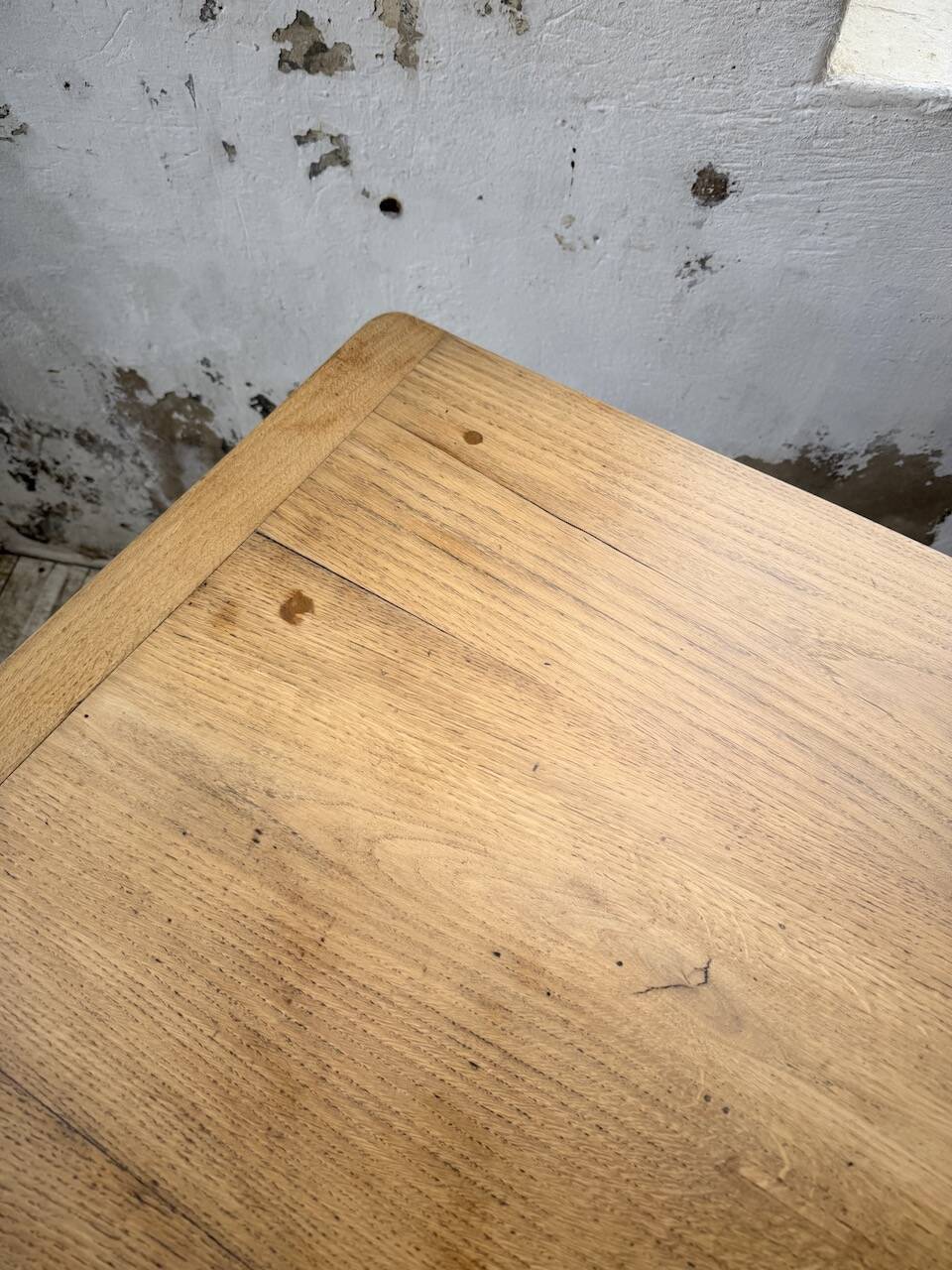 Oak farmhouse table with turned black legs.