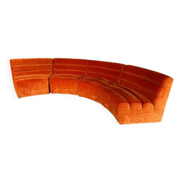 Burnt orange modular sofa for four with a futuristic design.