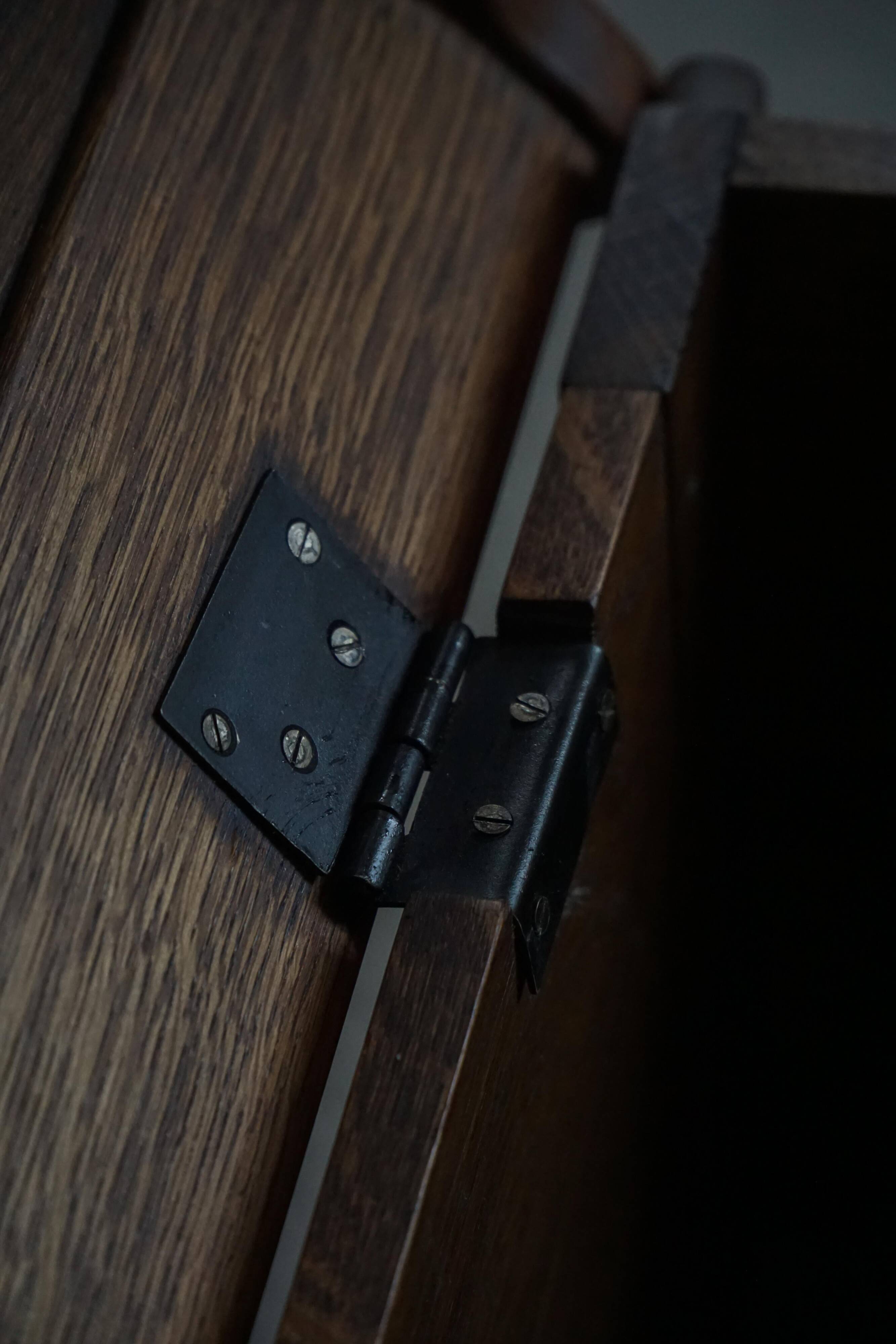 Modern Danish oak commode with decorative relief sculpture, mid-20th century.