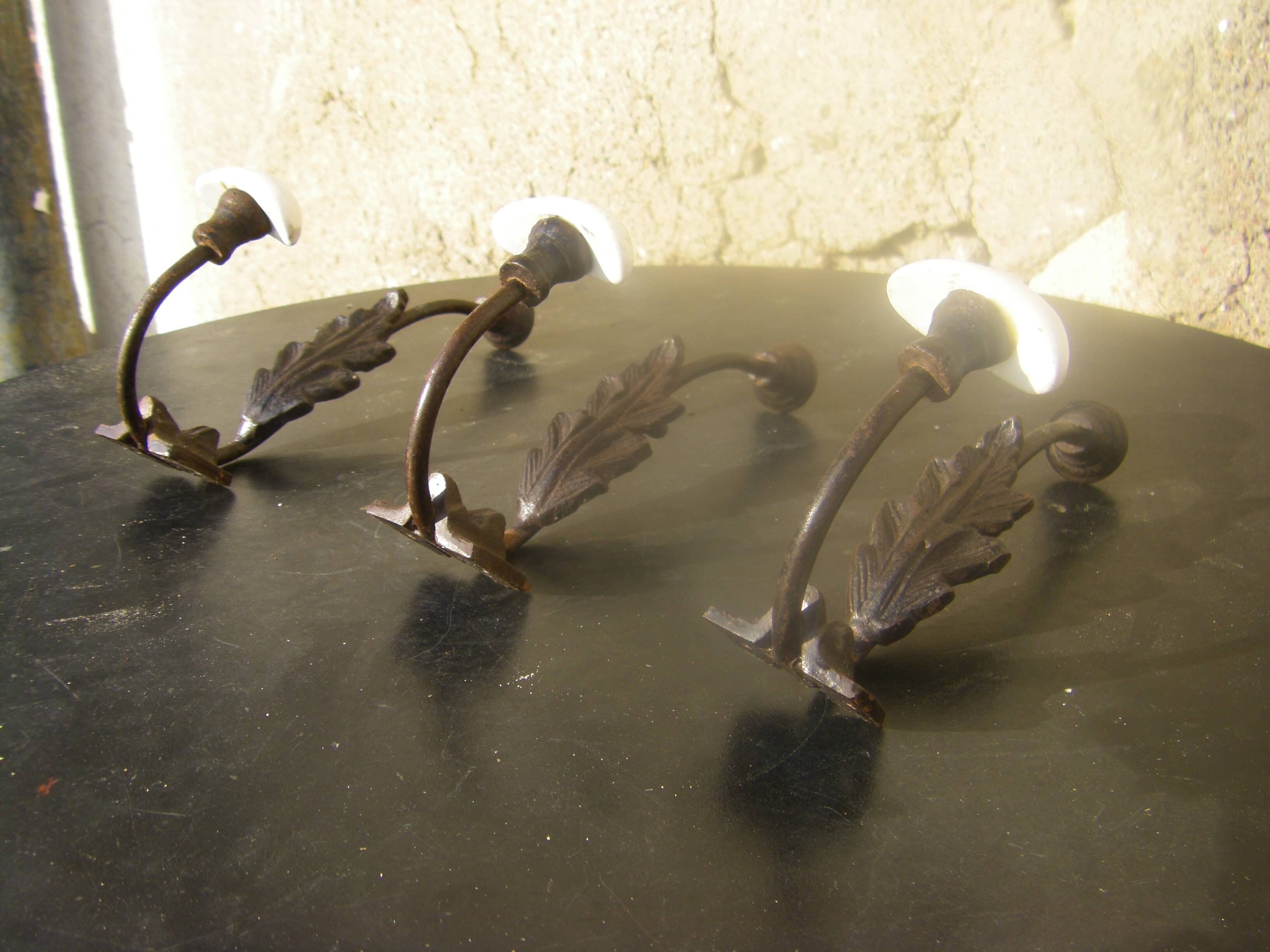 Trio of vintage coat hooks.