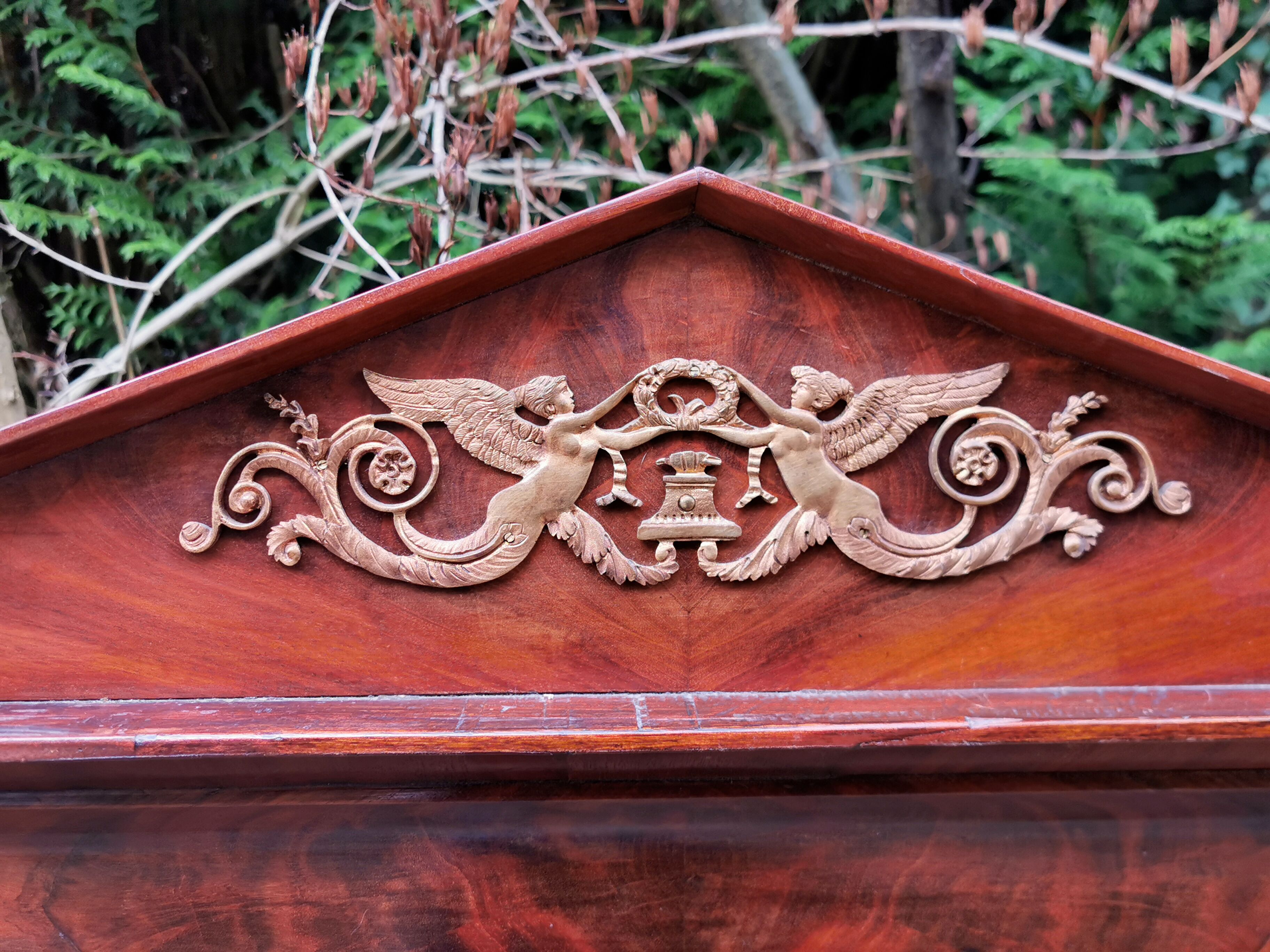 Mahogany pediment mirror with Empire-style cariatids. Return from Egypt