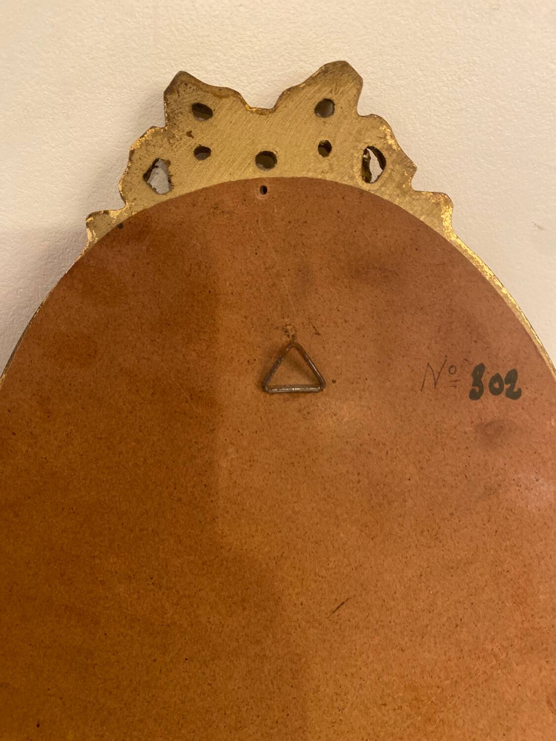 Golden oval wooden frame