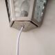 Half grey metal wall sconce and 3 windows
