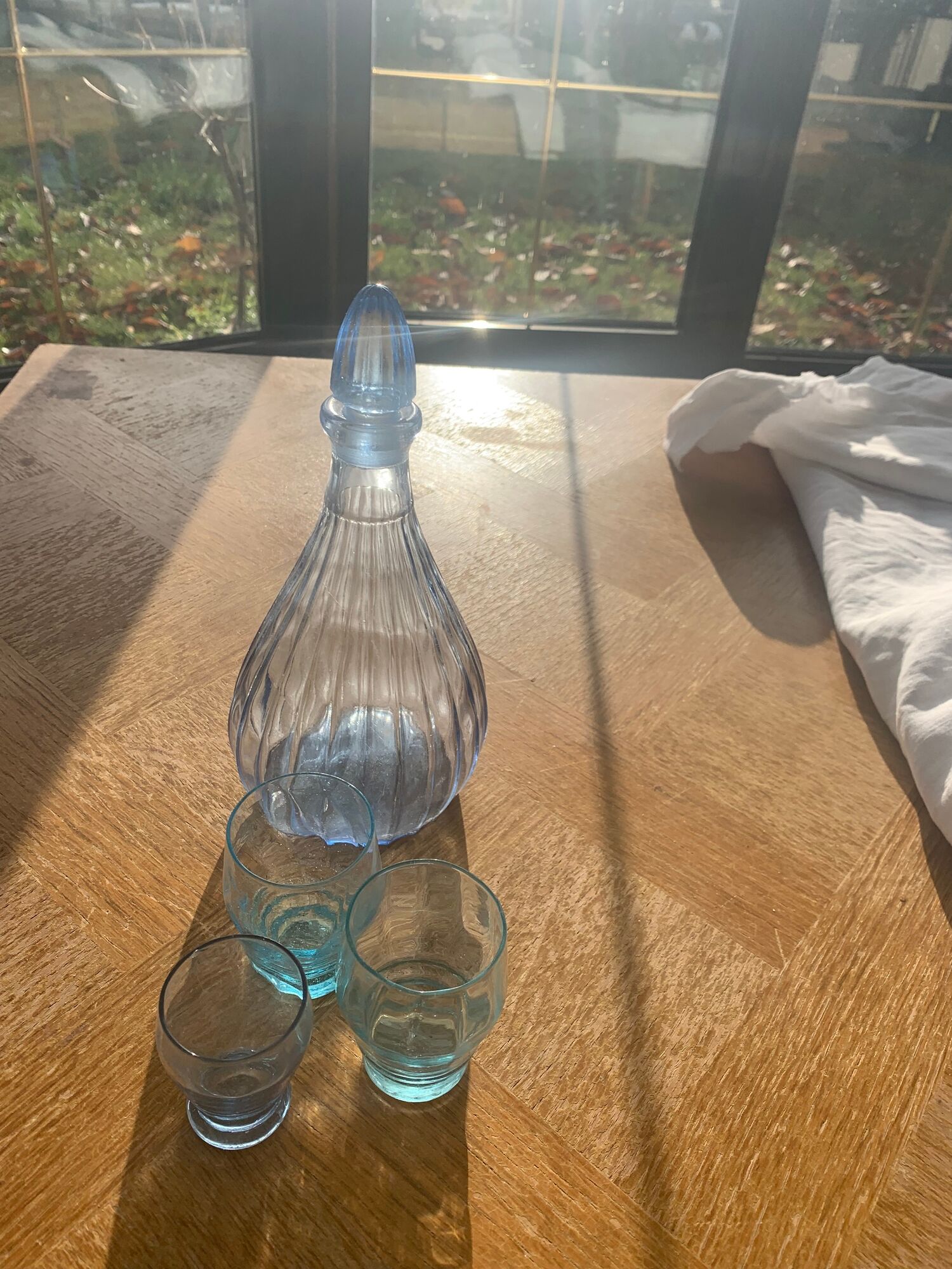 Liquor service consisting of a blue glass decanter and. 3 small antique glasses