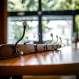 Vintage industrial wooden coat rack with porcelain hooks