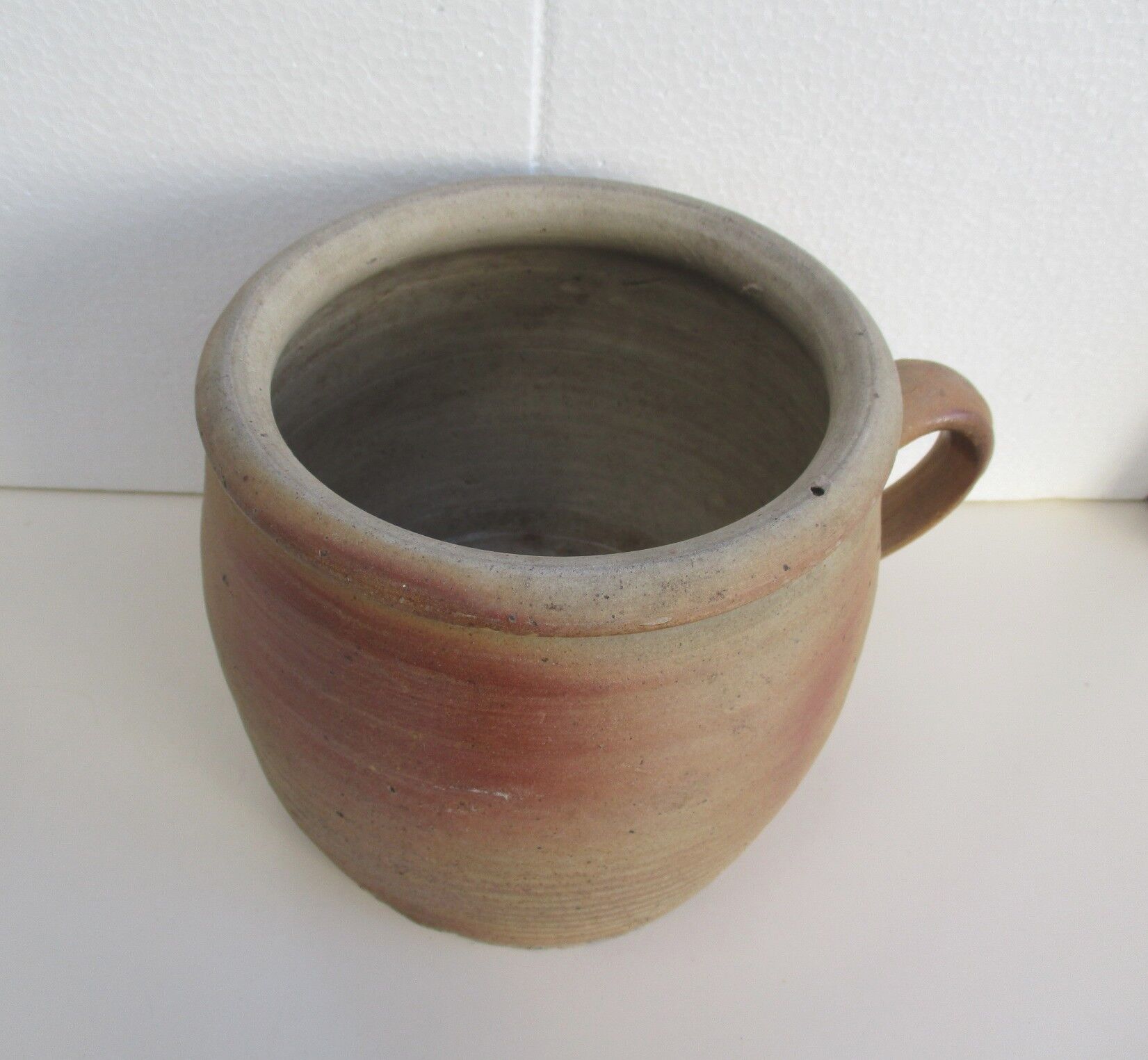 Ancient sandstone pot at one handle
