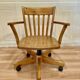 Solid wood swivel and reclining armchair.