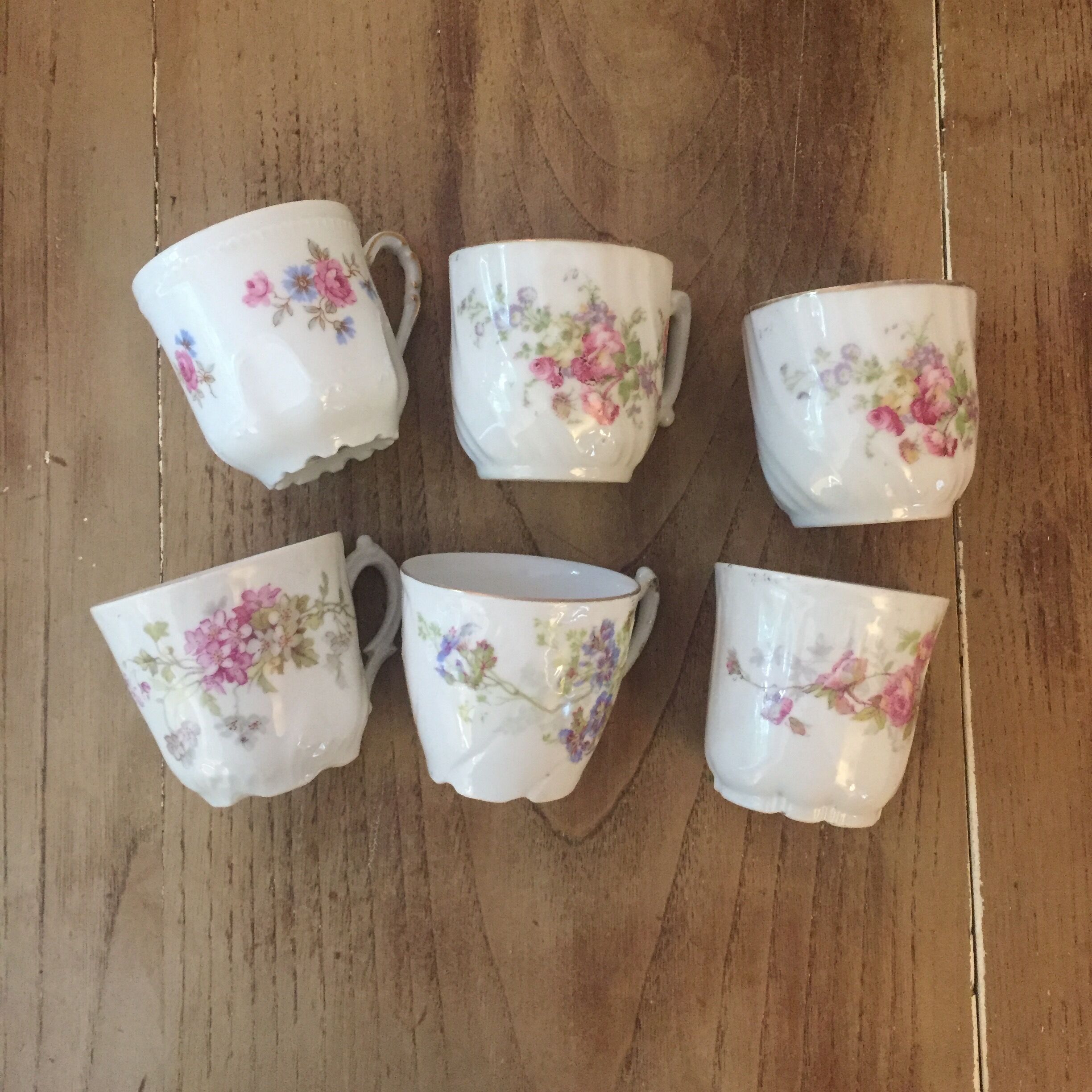 6 antique cups and mismatched saucers