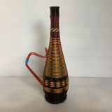 Old bottle in yellow, red and black scoubidou