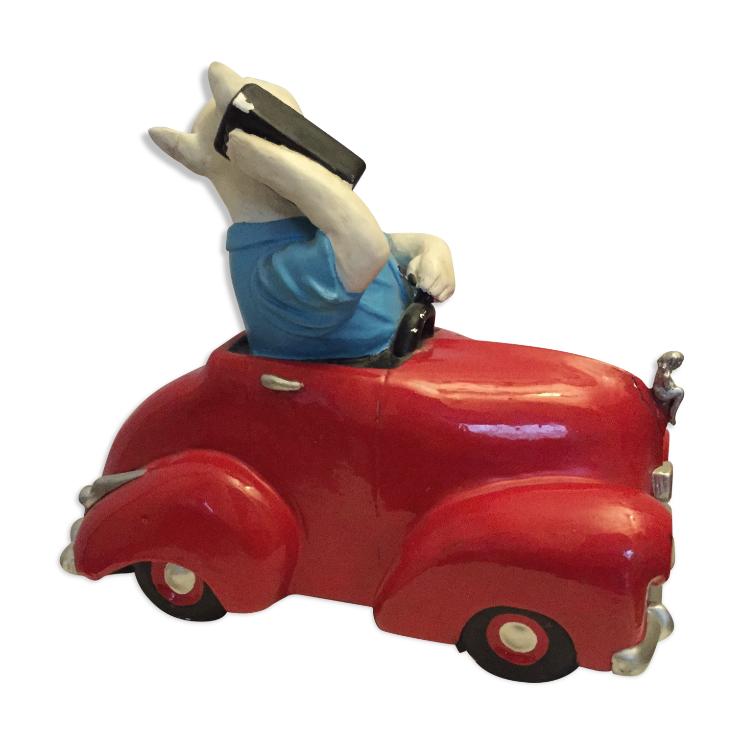 Dog toy driving his red car