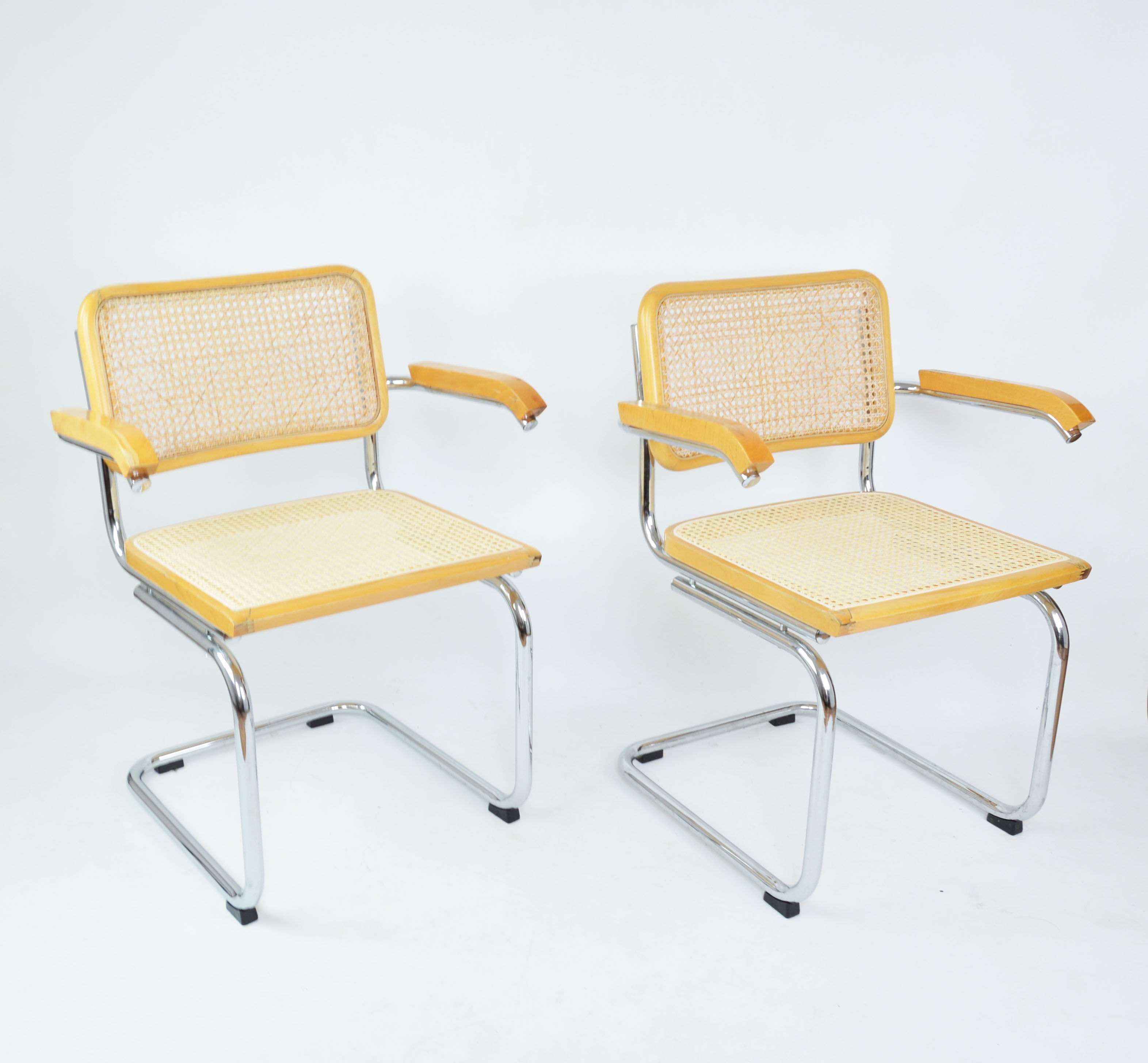 A pair of chairs with armrests, 1970s
