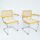 A pair of chairs with armrests, 1970s