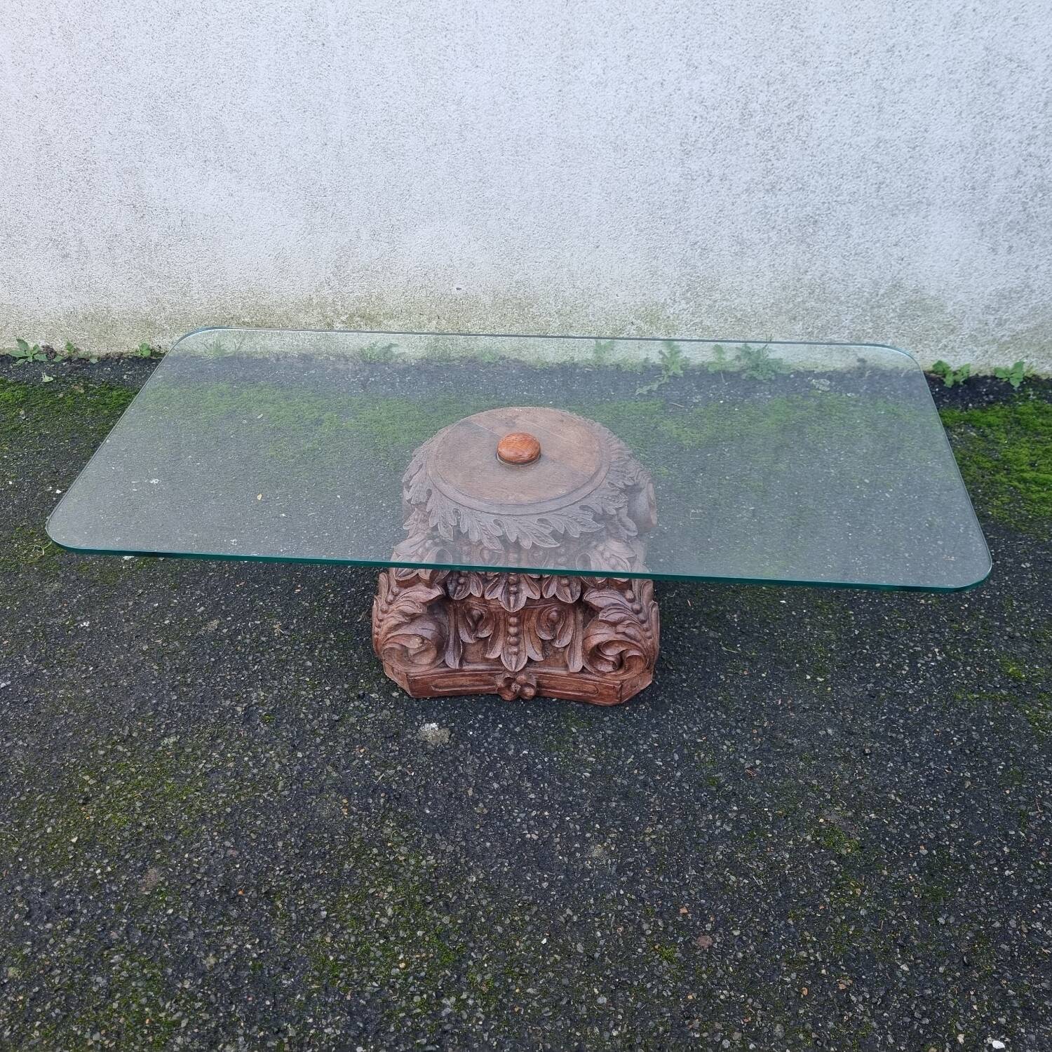 Coffee table with carved wooden base from India, glass top