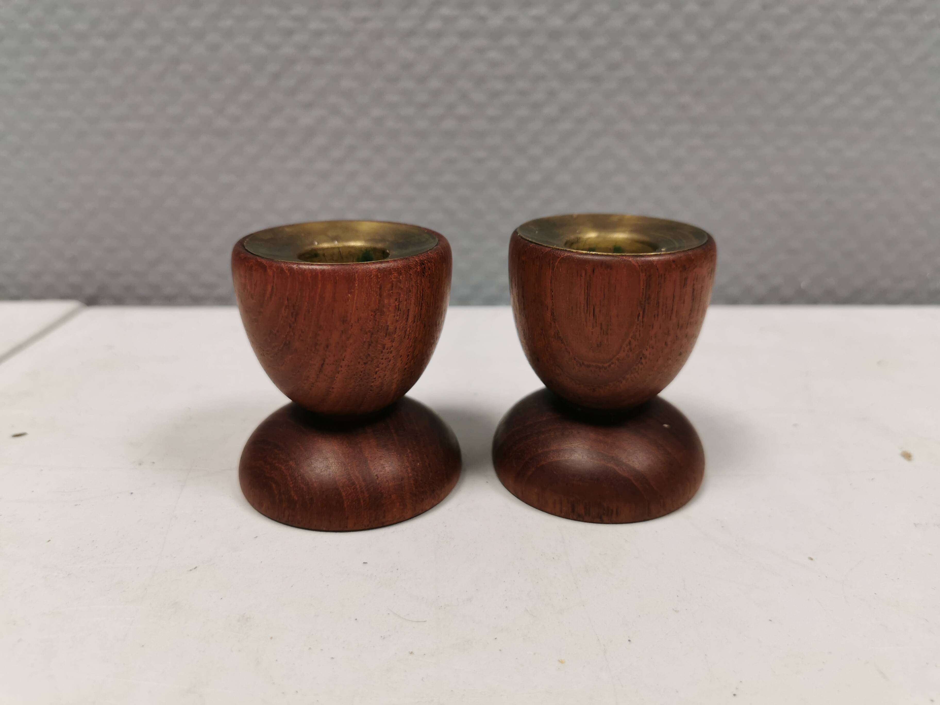 Two beautiful teak candle holders with brass inserts.