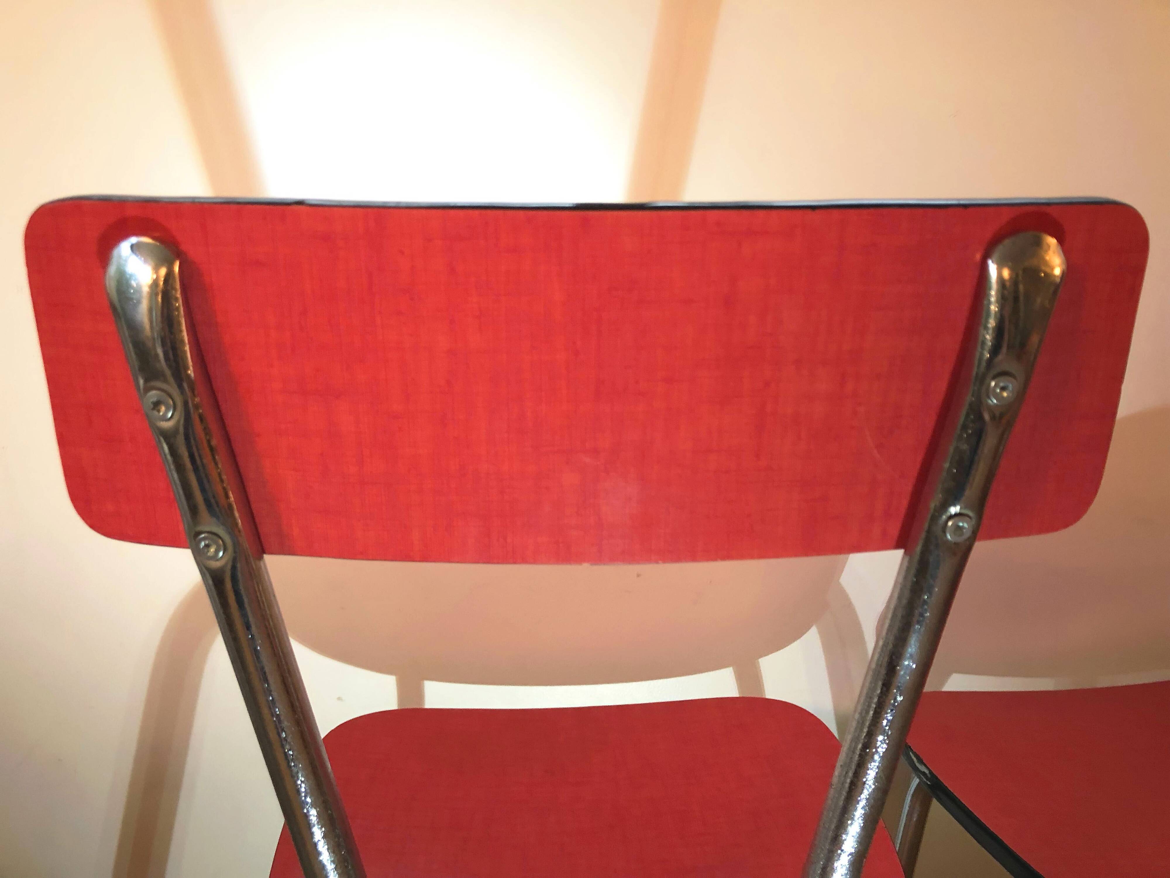 Duo of red formica chairs