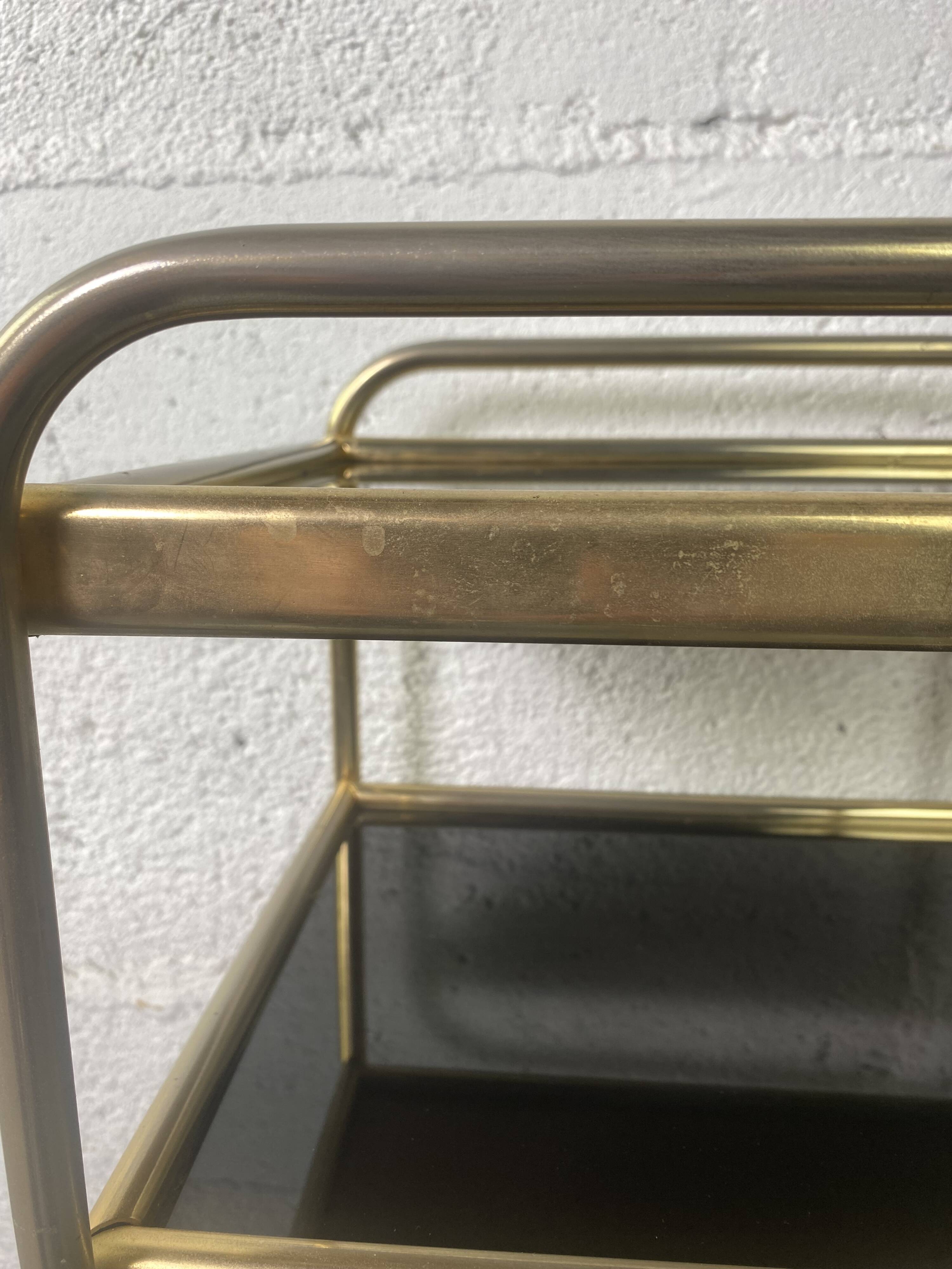 Small rolling trolley in brass and black plastic
