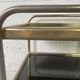 Small rolling trolley in brass and black plastic