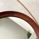 Mid Century solid teak wall mirror with a leather strap - Danish design