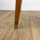 Wooden stool with red faux leather from the 1950s.