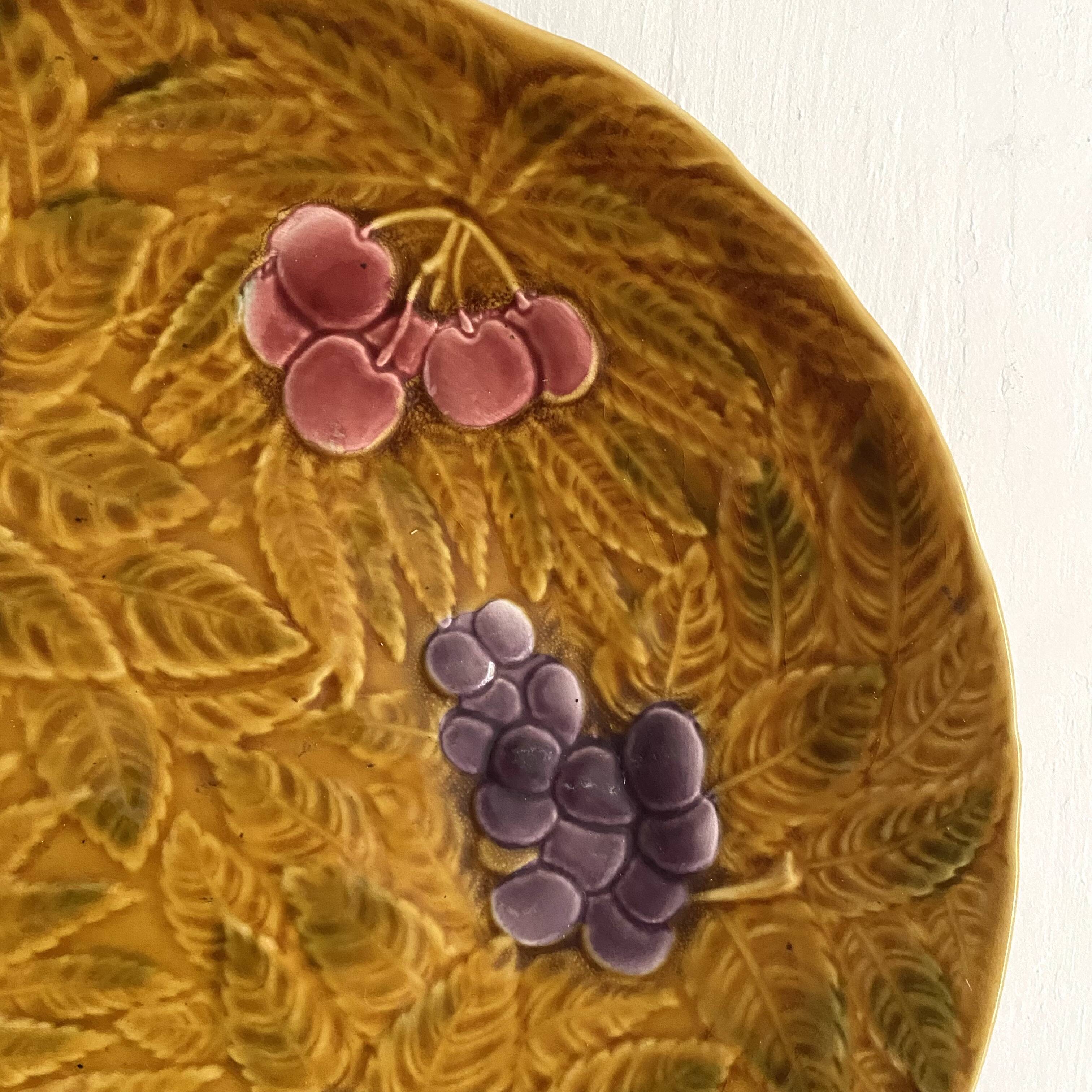 Large round Sarreguemines slip dish with fruit decoration