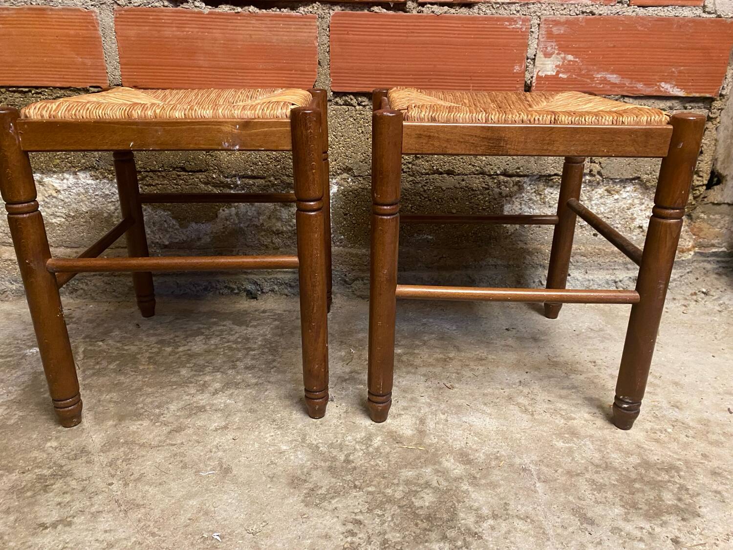 Pair of vintage wooden stools with woven straw seats