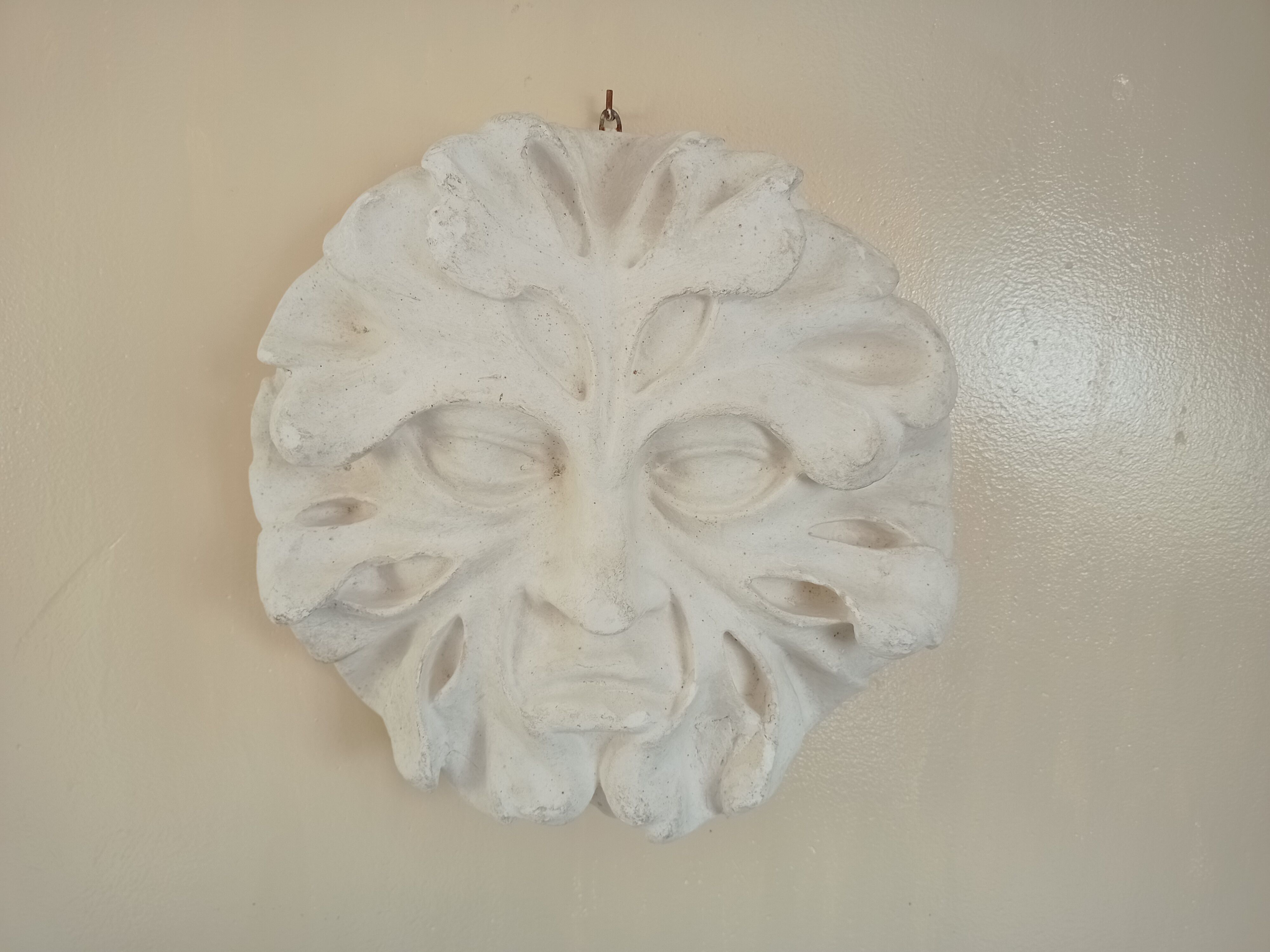 Bas relief sun in plaster