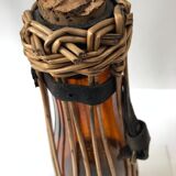 Amber and wicker glass bottle