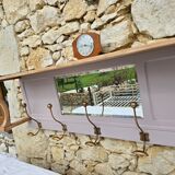 Coat rack or wall-mounted entrance wardrobe with scroll arms and antique hooks.