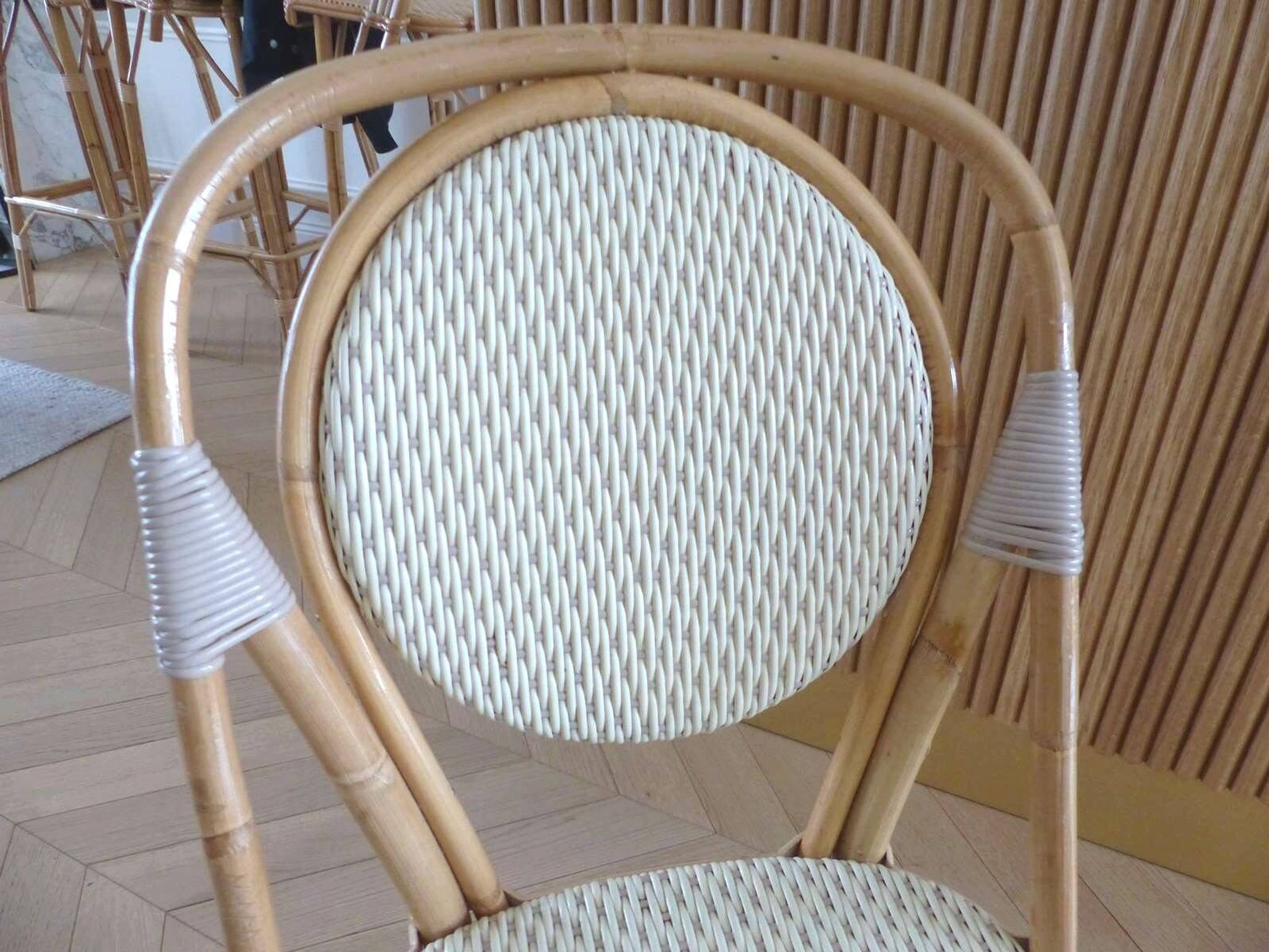 Pair of Parisian bistro chairs from Maison Louis Drucker in light Manila rattan.