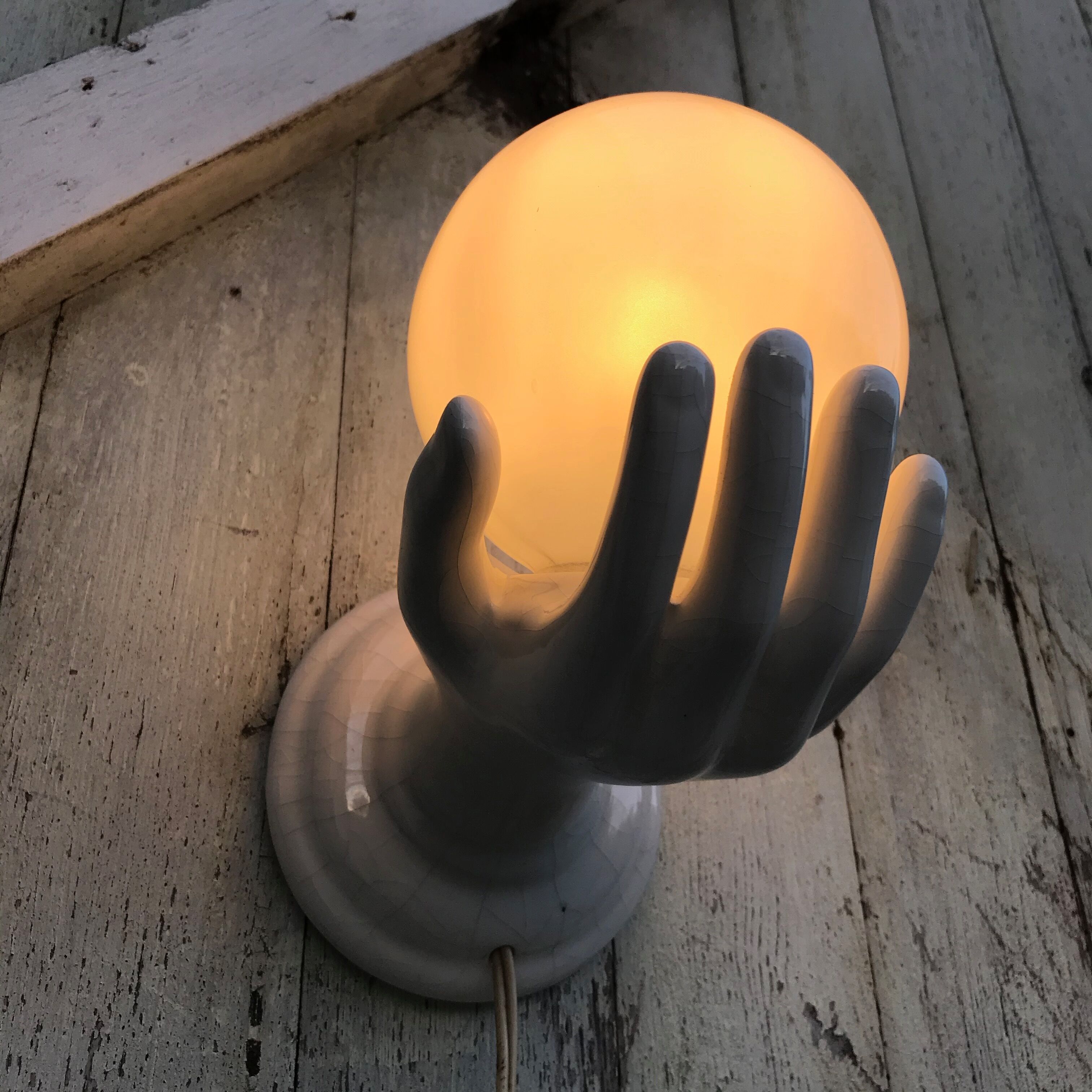 Hand-shaped ceramic wall light