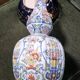 Large earthenware vase with a baluster body and elongated neck, richly decorated.