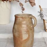Old rustic stoneware jar with handle