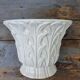 Important white earthenware pot cache with leafy decoration