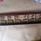 Coat rack, teak and brass coat hooks.