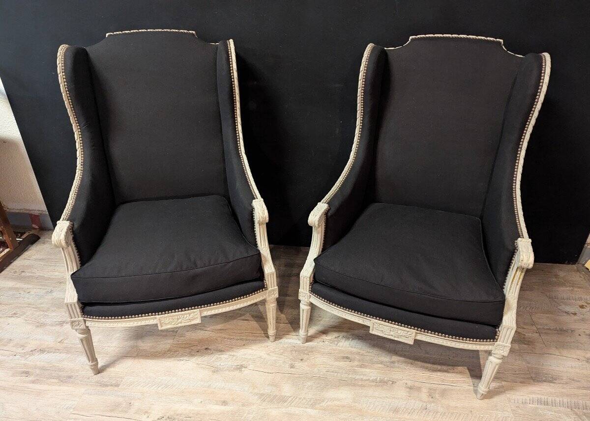 Pair of Louis XVI armchairs with ears in grey painted wood and black fabric.