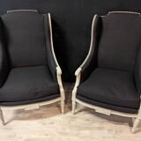 Pair of Louis XVI armchairs with ears in grey painted wood and black fabric