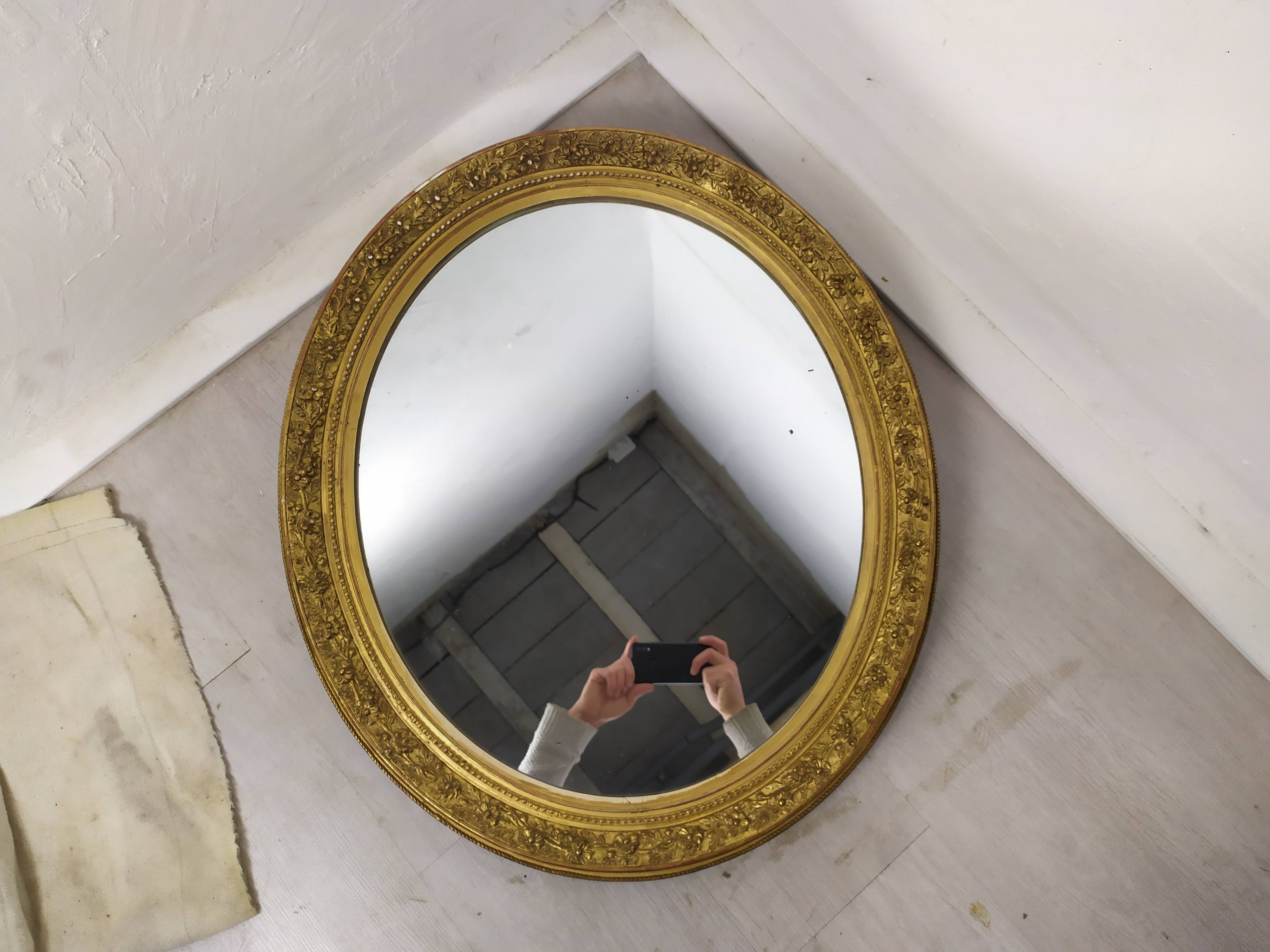 Golden oval mirror