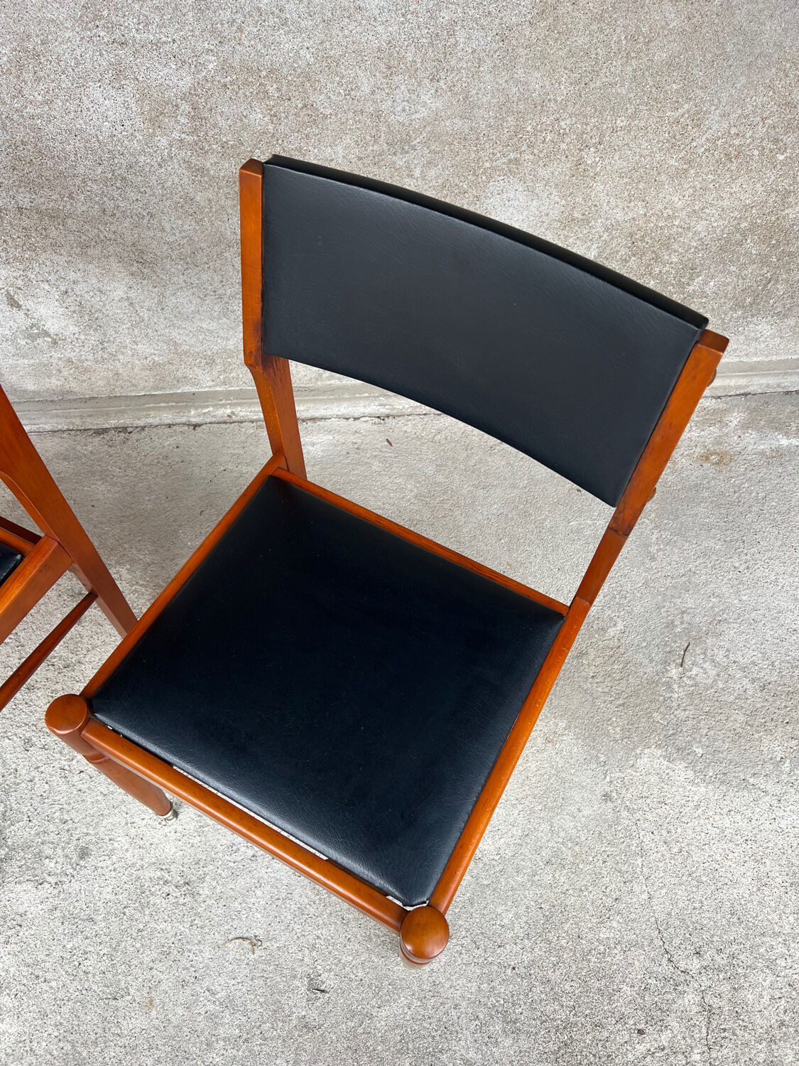 2 wooden and faux leather chairs in Scandinavian style