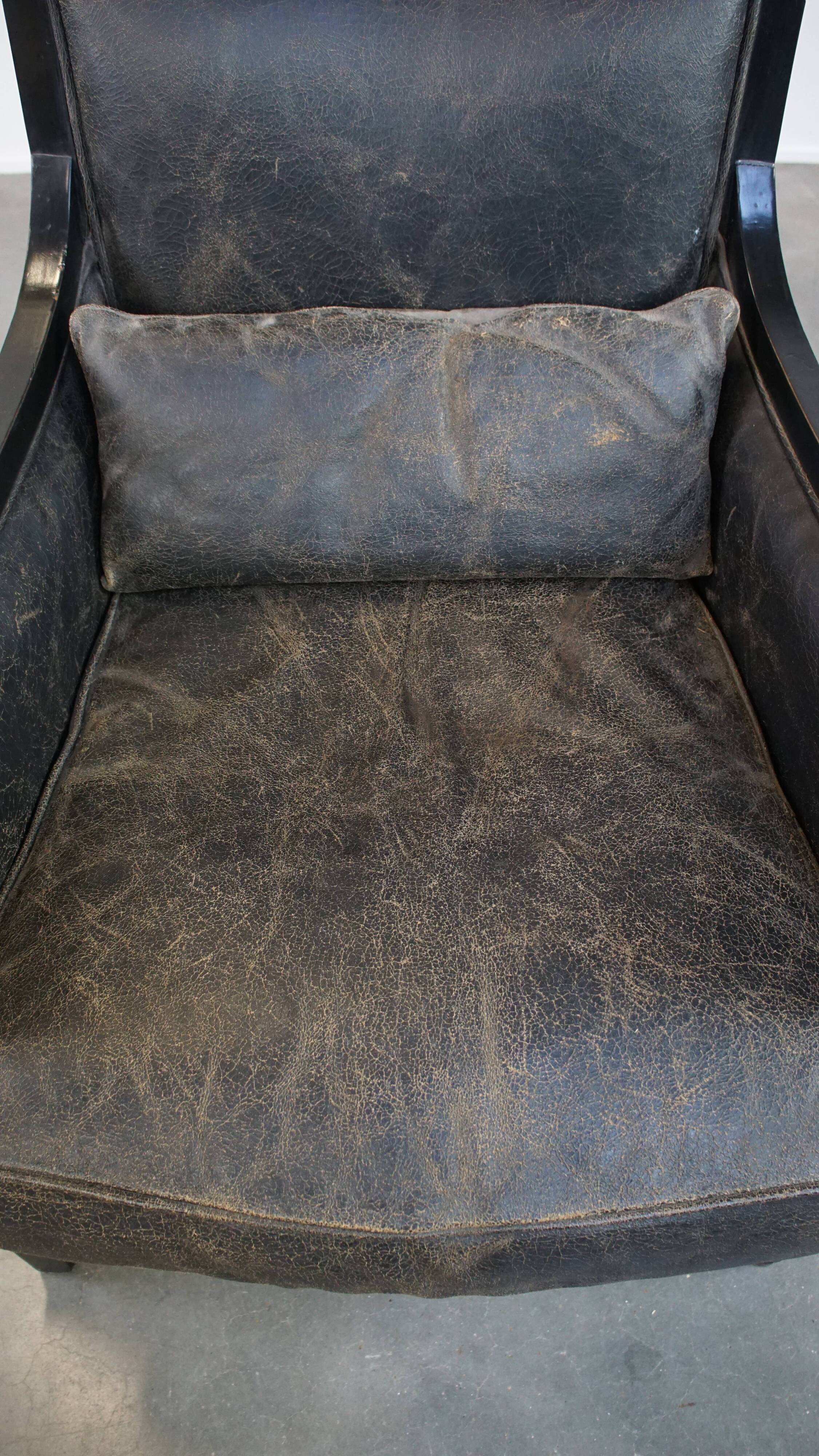 Armchair in black cowhide leather and wood with an Art Deco design