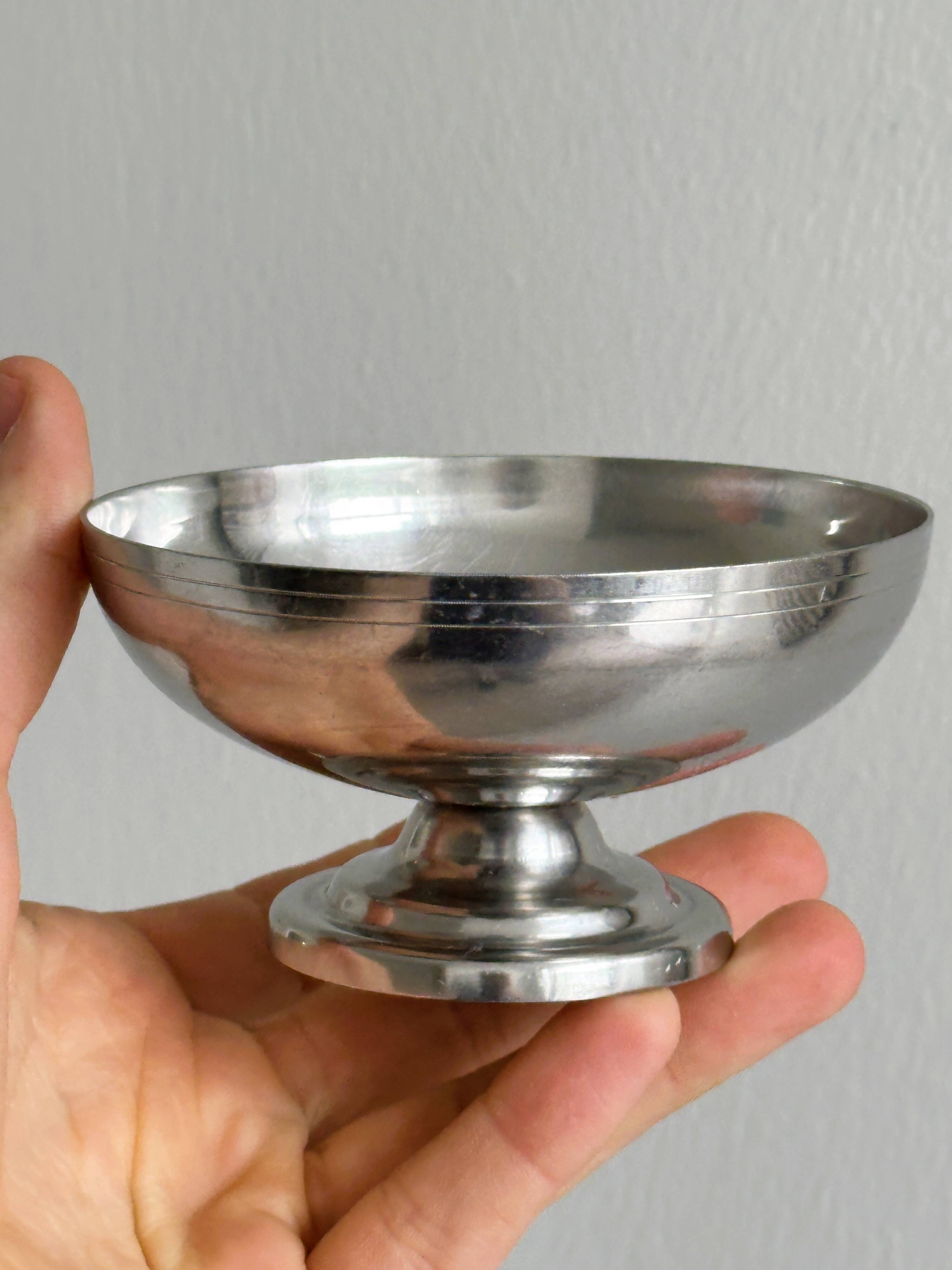 5 silver metal cups.