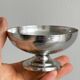 5 silver metal cups.