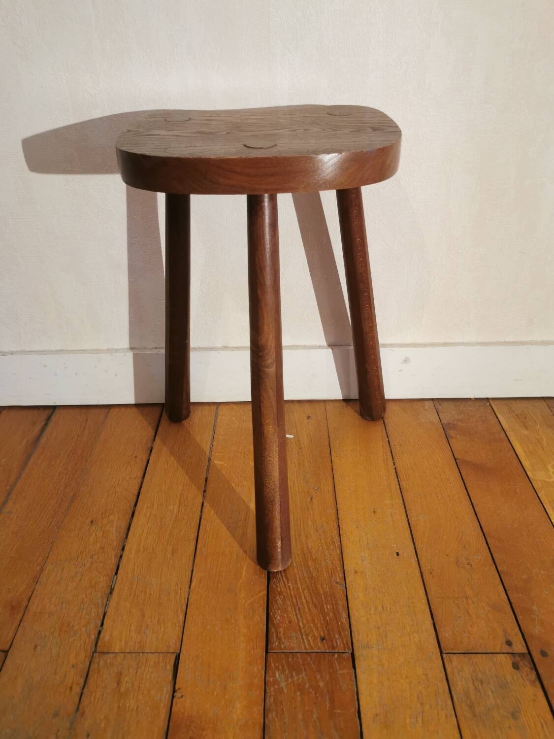 Old wooden tripod bench stool milking shepherd’s bench