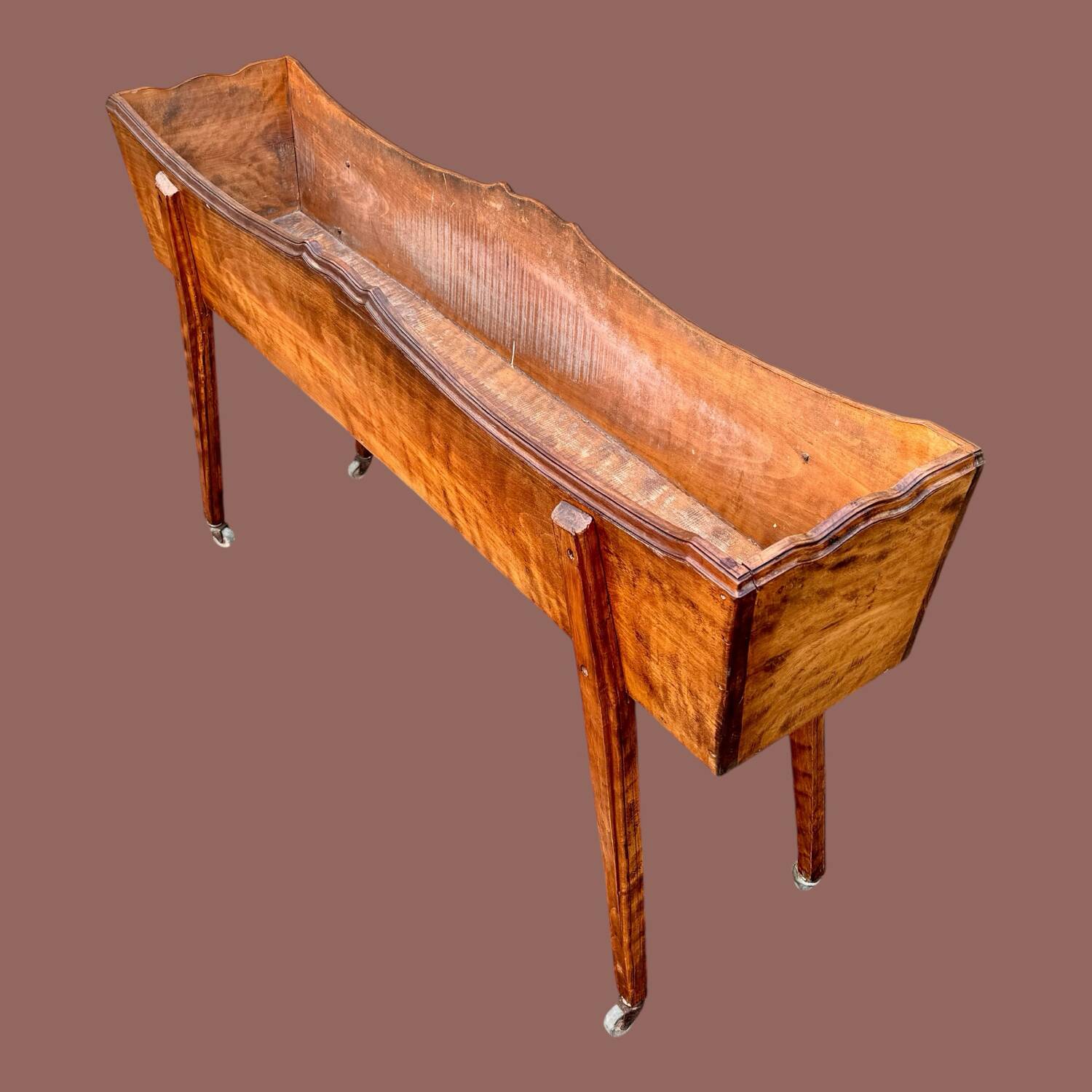 Old indoor planter on wheels