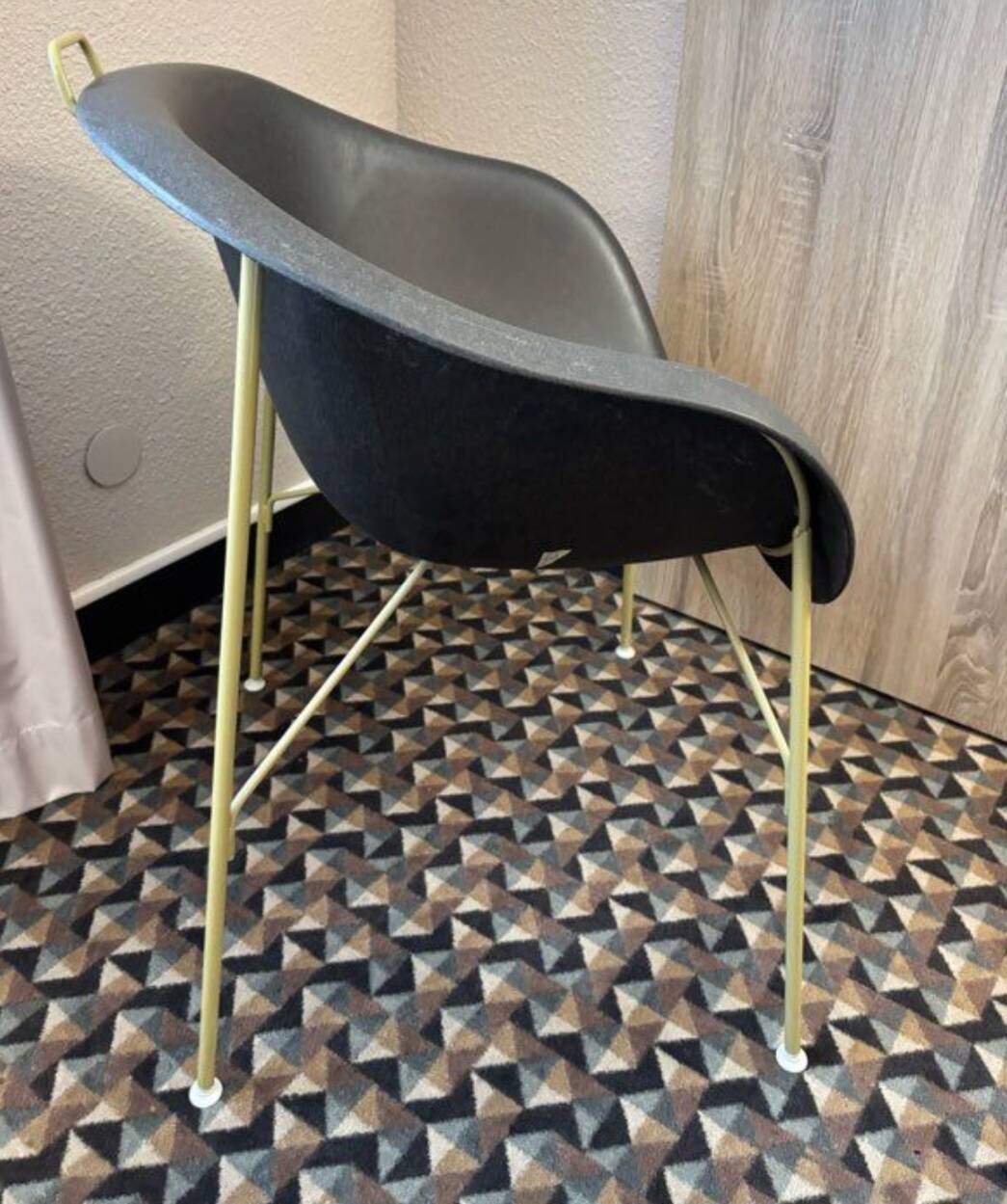 Designer armchair with a black shell – metal frame