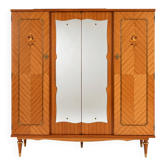 Vintage 1970s wardrobe with floral marquetry, mirrors, and gold details.