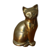 Cat sitting in brass