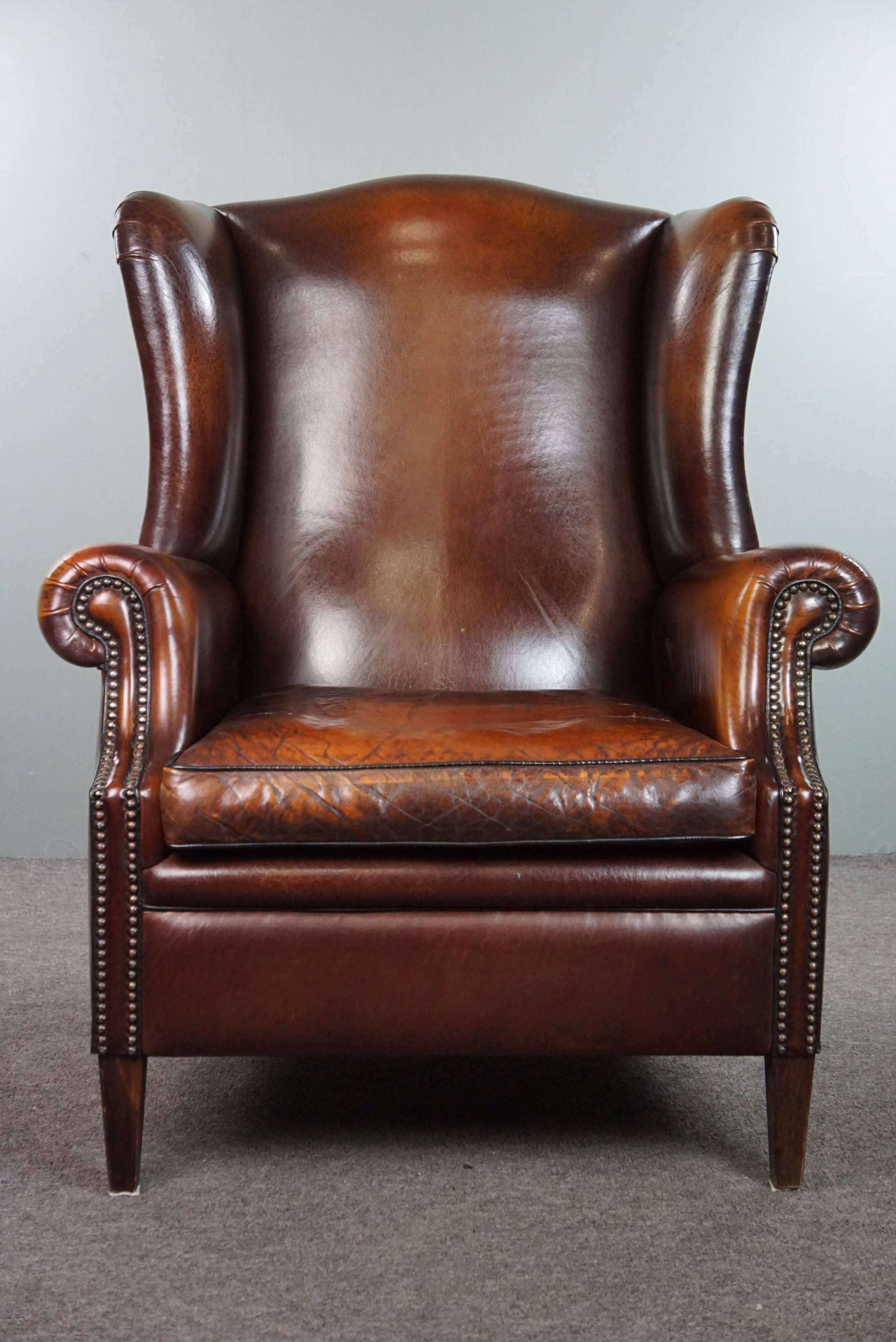 Luxurious large sheep leather wingback armchair with beautiful colors and amazing patina