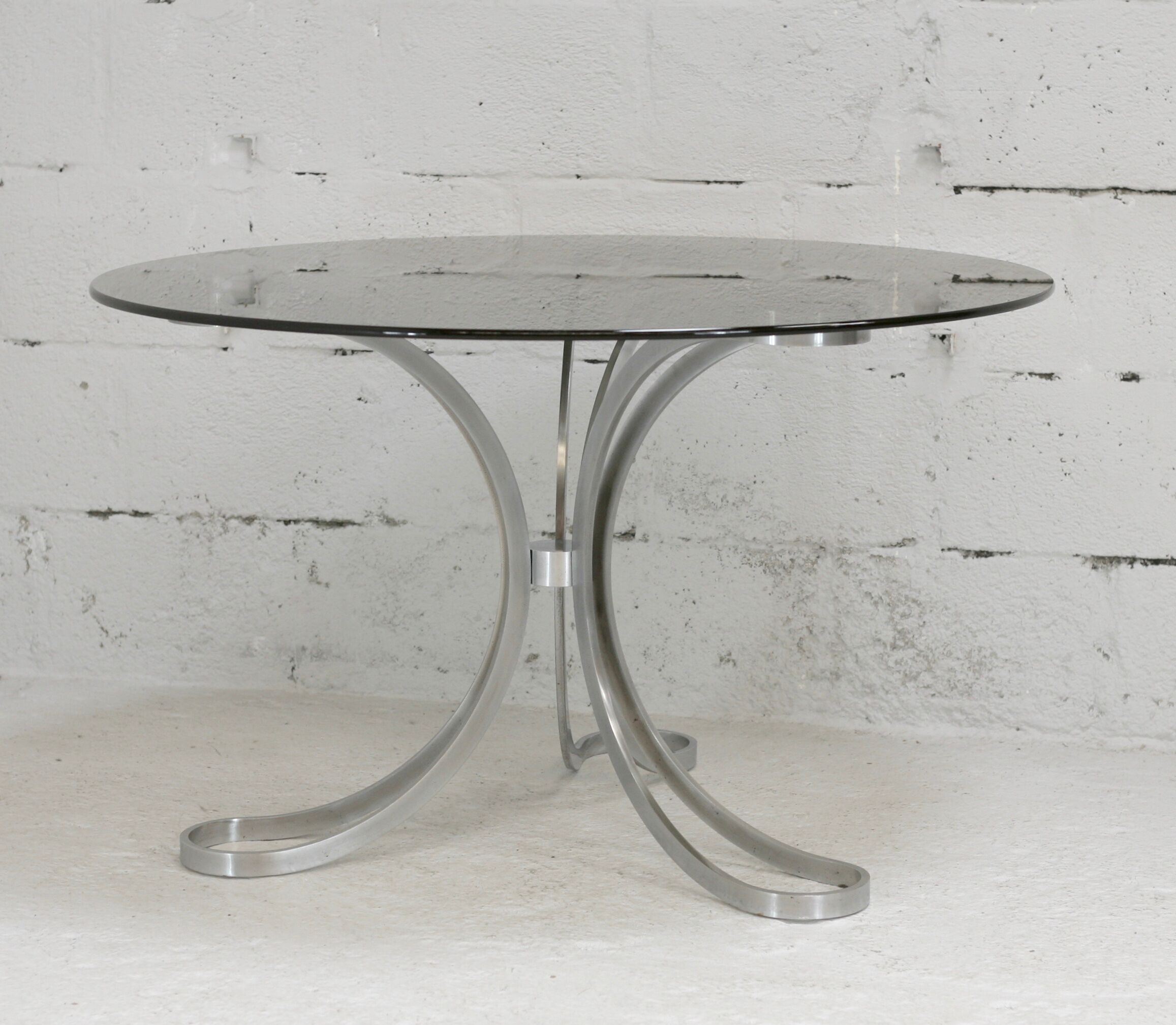 Living room table "Space Age" polished steel, circular slab smoked glass. France, circa 1970.